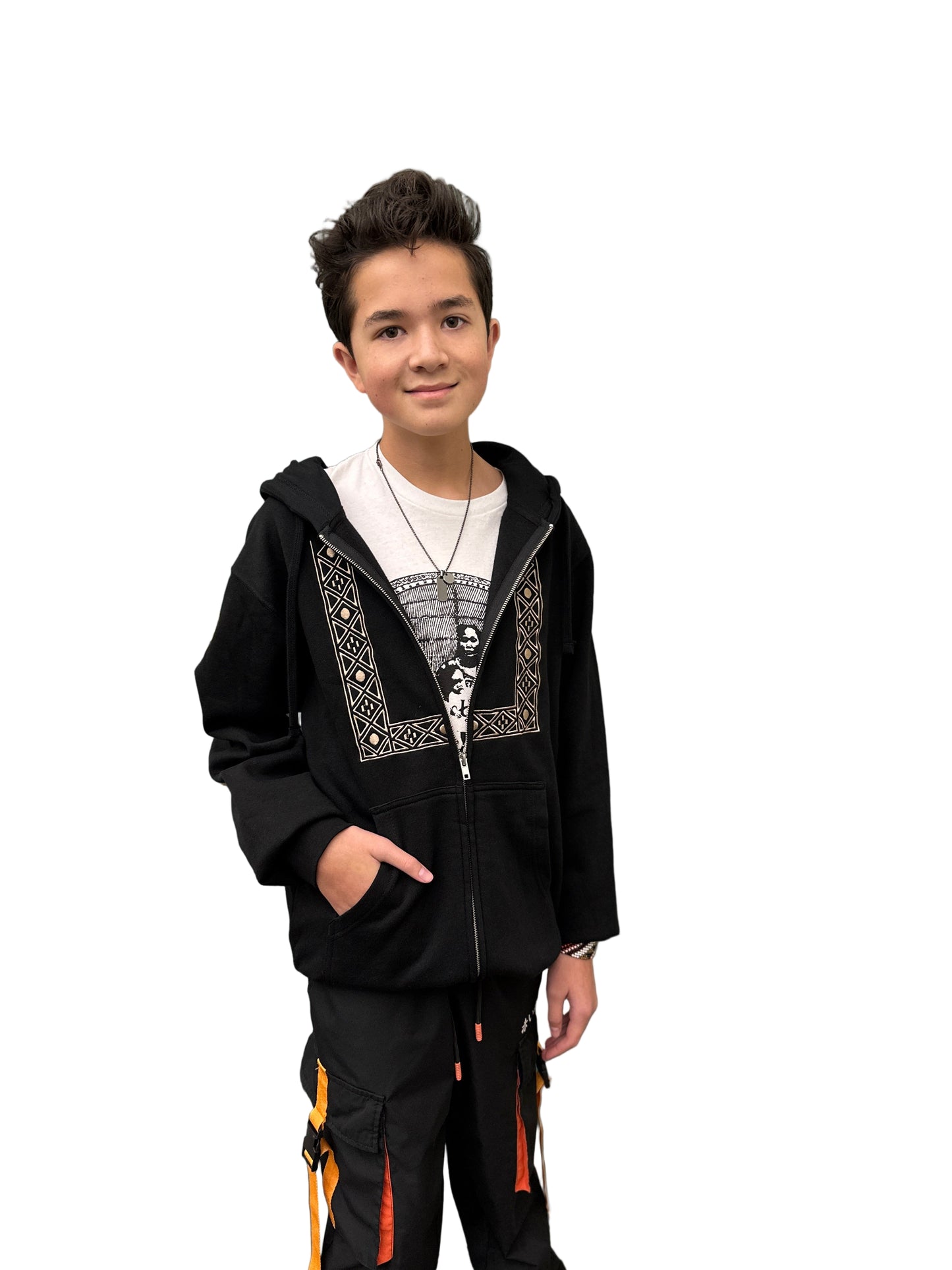 Person wearing a black embroidered hoodie with decorative elements and black pants with orange accents and white printed undershirt.